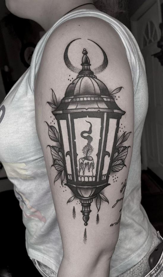 a woman with a lantern tattoo on her arm