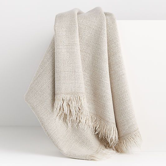 a white blanket with fringes on it