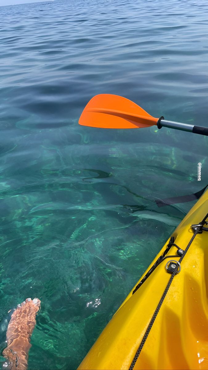 an orange kayak is in the clear blue water