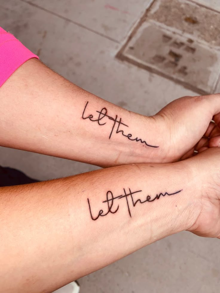 two people with matching tattoos on their arms that say, let them be there and the rest is written in cursive font