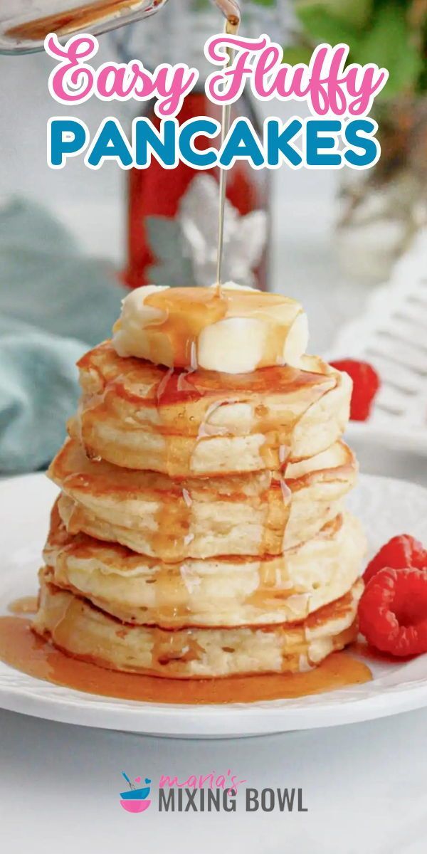 a stack of pancakes sitting on top of a white plate with syrup being drizzled over them