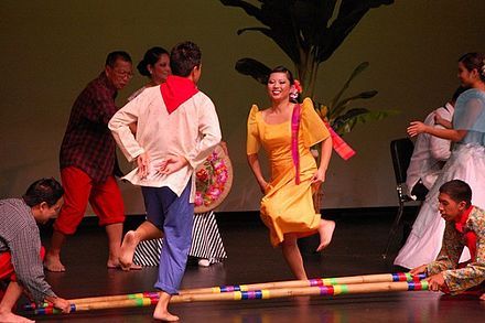 a group of people standing on top of a wooden floor next to eachother