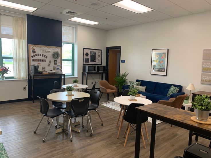 a room with several tables and chairs in it