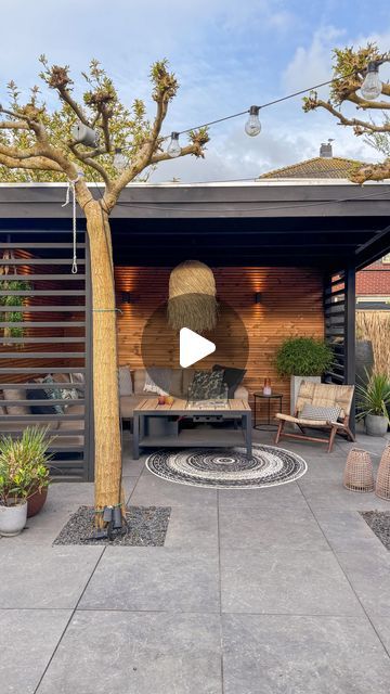 an outdoor living area with patio furniture and potted plants