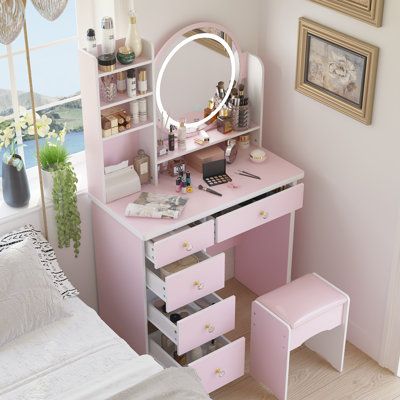 a bedroom with a pink vanity and mirror