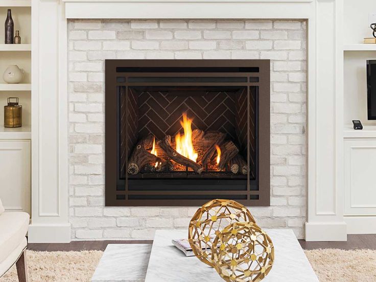 a living room with a fire place in the center and shelves on either side of the fireplace