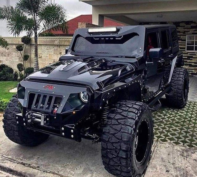 a black jeep parked in front of a house