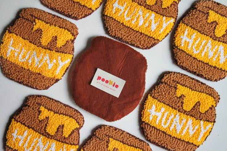 six cookies are decorated with brown and yellow frosting