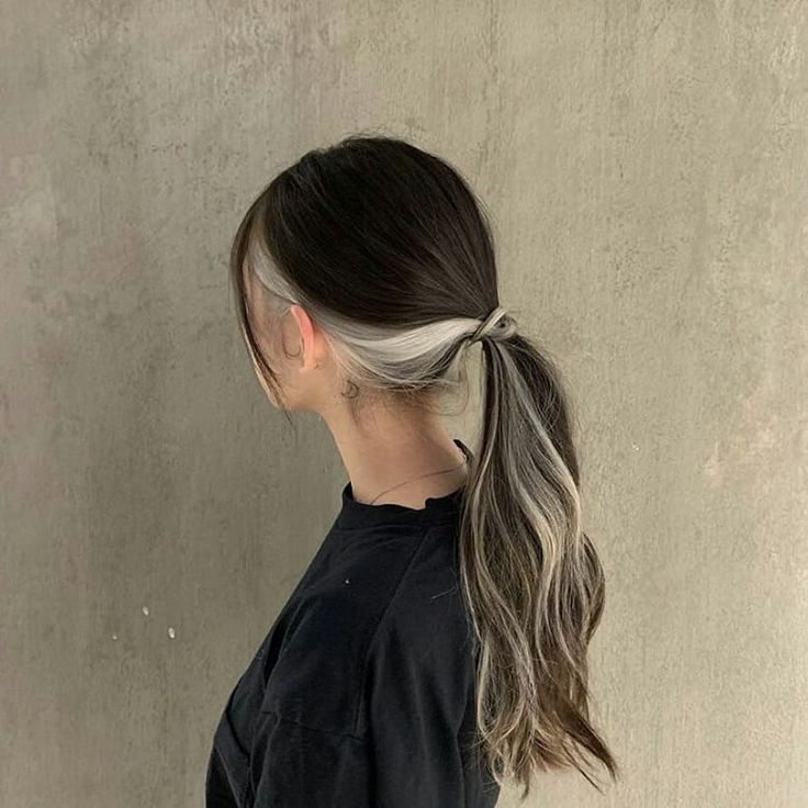 a woman with her hair in a pony tail styled into a half - up ponytail