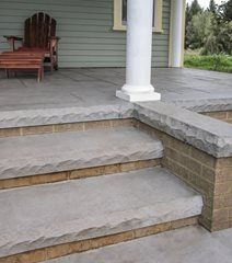 a porch with steps leading up to the front door