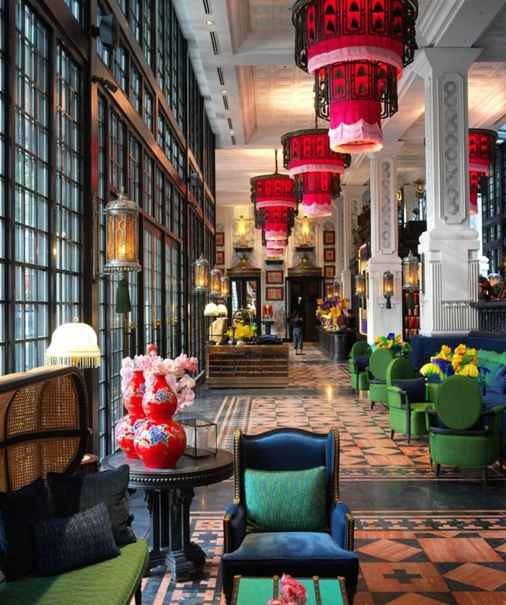 the lobby is filled with colorful chairs and tables