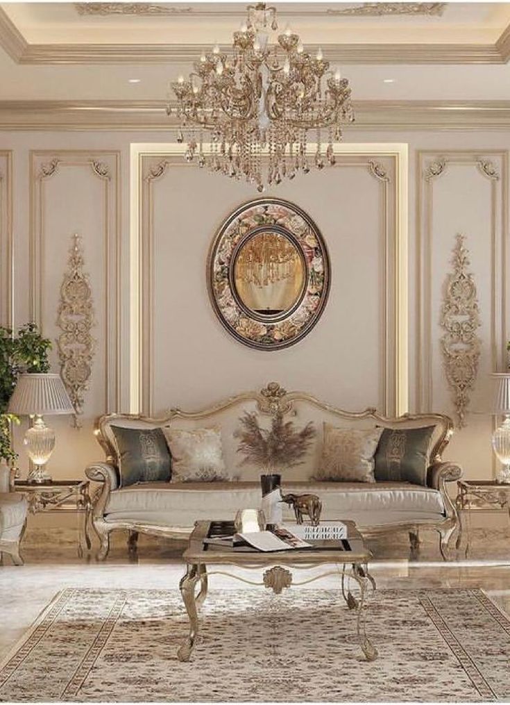 a fancy living room with chandelier, couch and coffee table in the center