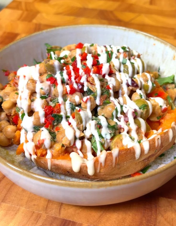 a white bowl filled with food on top of a wooden table