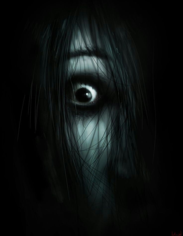 an evil looking woman's eye with long hair and dark makeup on her face