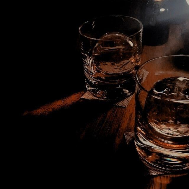 two glasses sitting on top of a wooden table