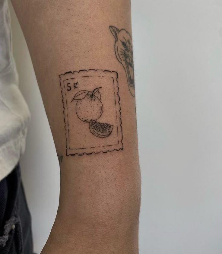 a small tattoo on the arm of a person with an apple and banana in it