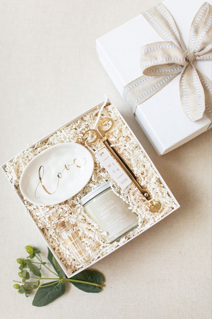 an open gift box with a white bow on it