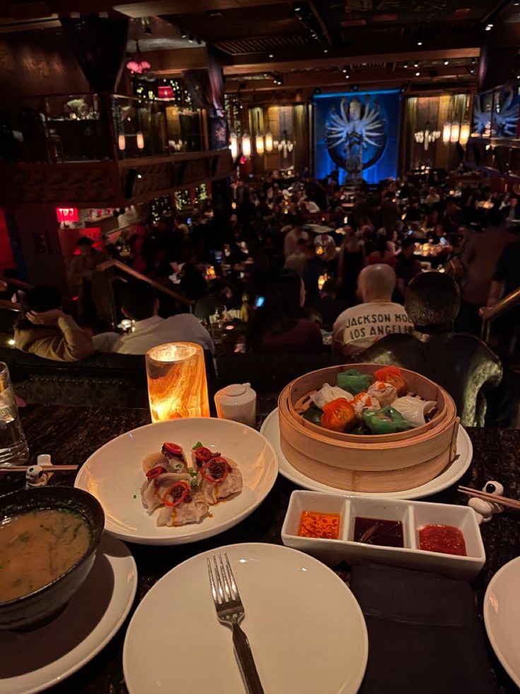 a table filled with plates and bowls of food