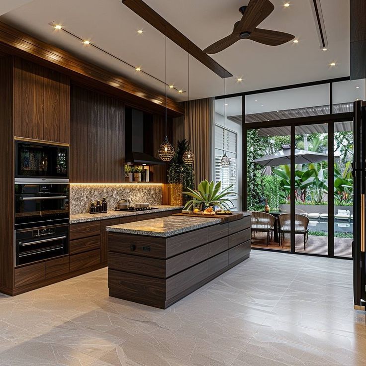 a modern kitchen with an island and ceiling fan