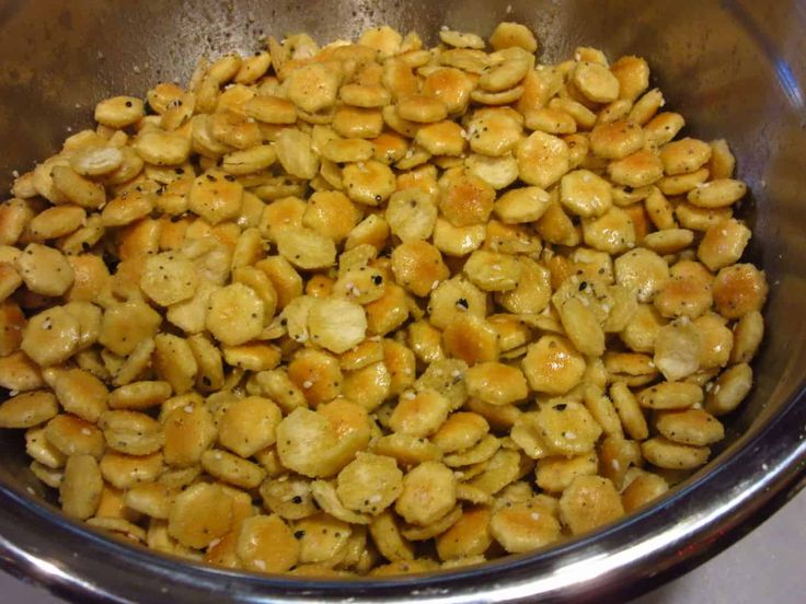 a metal bowl filled with food sitting on top of a stove