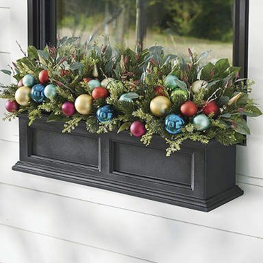 a window box filled with ornaments and greenery