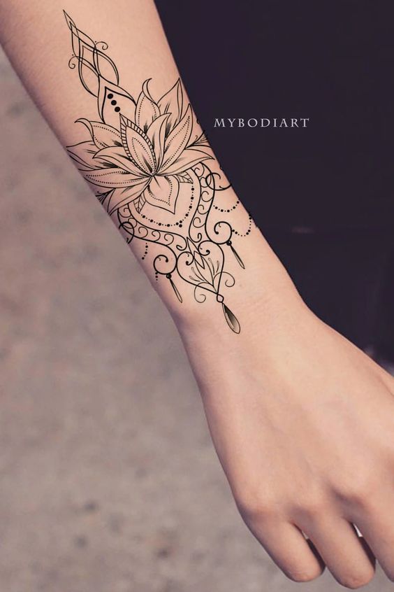 a woman's arm with a flower tattoo on it