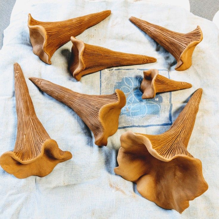 several pieces of carved wood sitting on top of a table