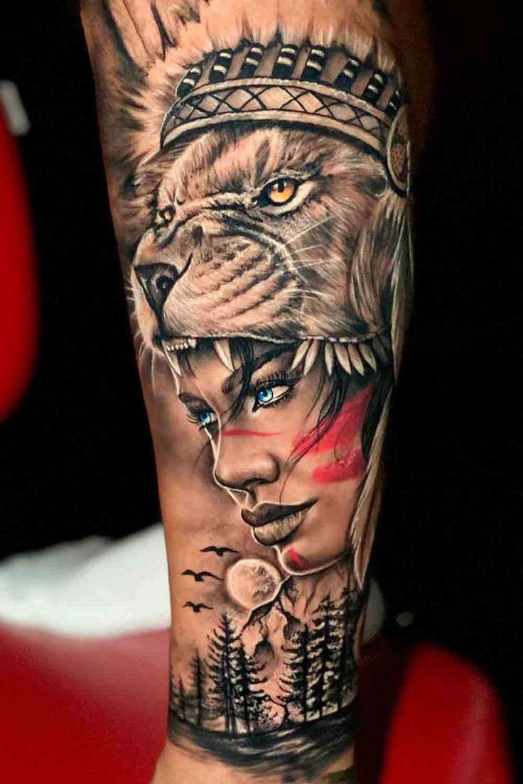 a man's arm with a tattoo on it and a lion wearing a headdress