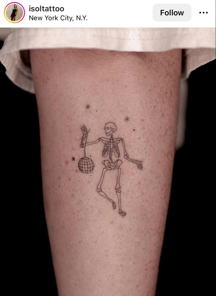 a person with a skeleton tattoo on their leg