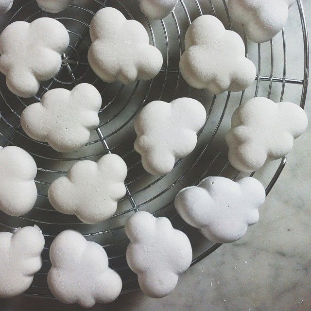 some white sugar hearts are on a cooling rack