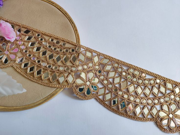 ♦ Feel Free to Message Me if Unable to Place your Order ♦ Elegant Rose Gold Embellishment perfect for designer clothing, Mirror work lace trim Vine, Bridal dress embellishment. Width : Approx. 8cm Length : 1 yard This beautiful lace trim is great for any sewing and craft projects. A perfect match for bridal dresses or any festive occasions. Our lace will add charm to your fabric, you can use this lace alone or add it with other laces to create a new unique design for, any of your project : ➤Dres Border Lace Design, Saree Lace Border Ideas, Mirror Work Lace Border, Saree Lace Border, Elegant Gold Fabric With Embroidered Border, Designer Mirror, Ceremonial Gold Fabric With Embroidered Border, Diy Belts, Mirror Trim