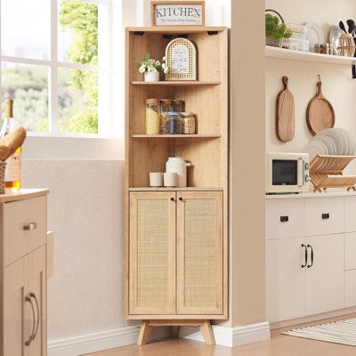 an open cabinet in the corner of a kitchen