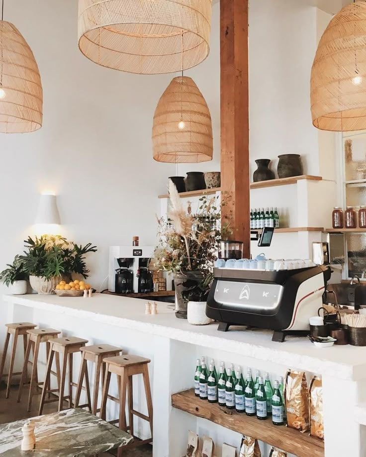 a counter with lots of bottles on it and hanging lights above the counter in front of it