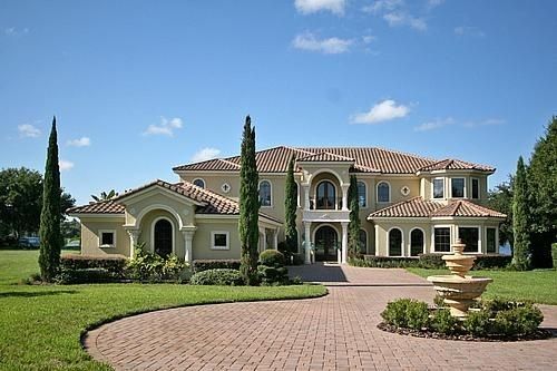 a large house with trees in the front yard