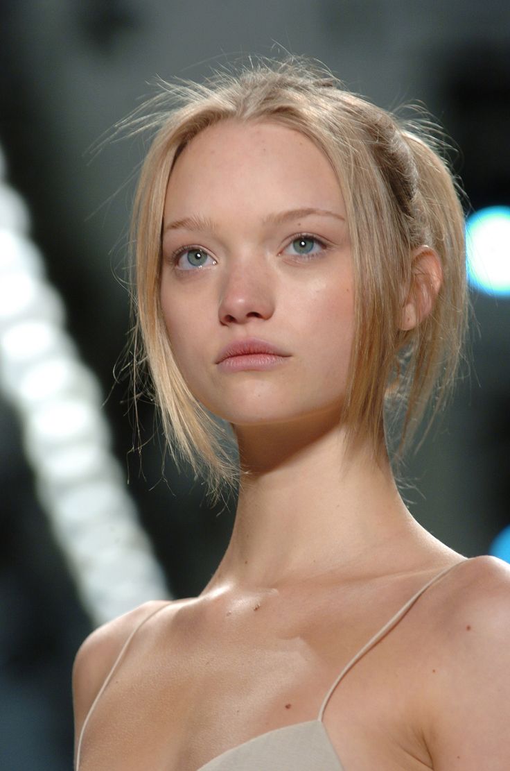 a woman with blonde hair and blue eyes on the catwalk at a fashion show