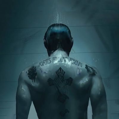 the back of a man with tattoos on his chest