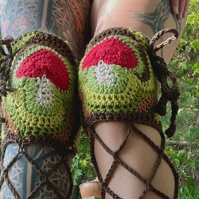 the legs are covered in crochet and have red, white, and green decorations on them