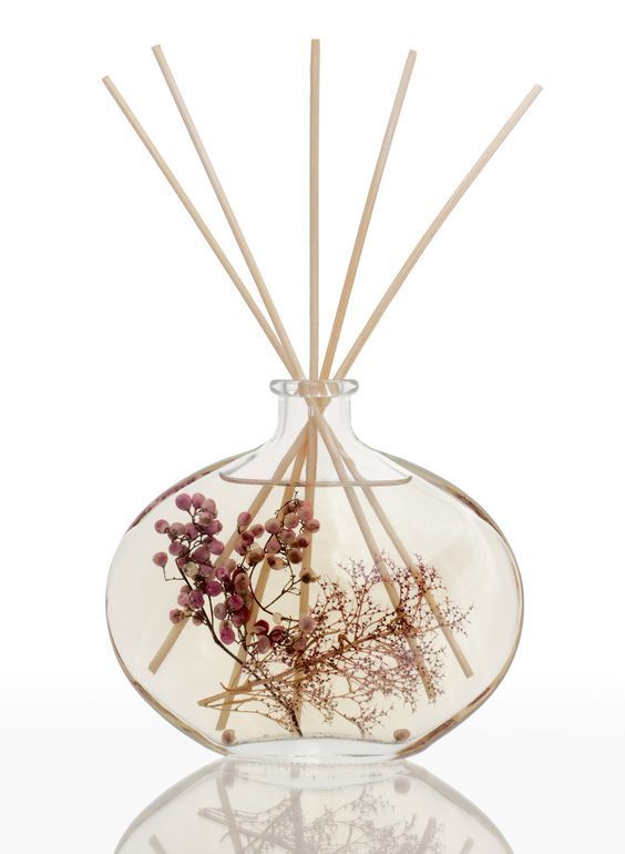 reeds and flowers in a clear glass vase