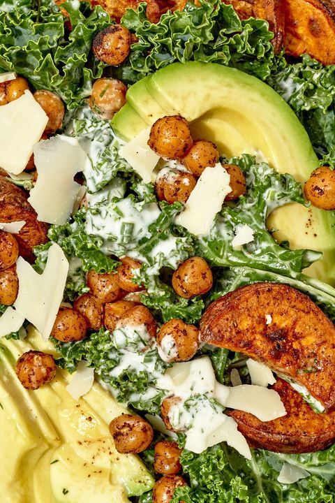 a salad with avocado, lettuce and chickpeas on it