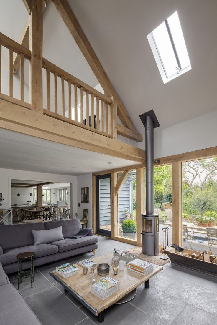 a living room filled with furniture and a fire place in the middle of a room