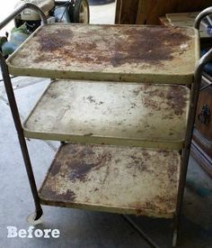 an old metal cart with three shelves on it