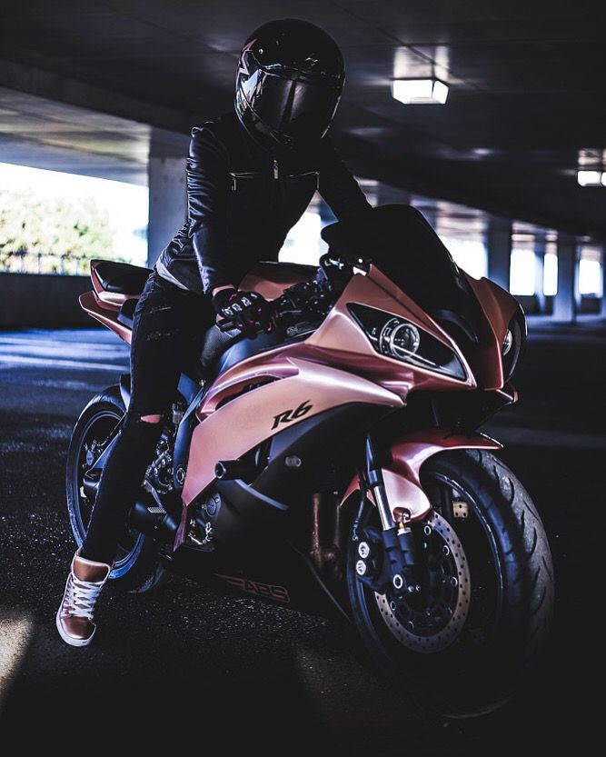 a person sitting on top of a pink motorcycle