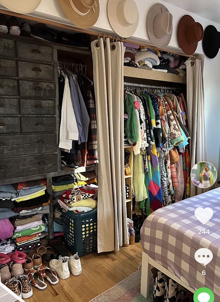 a bedroom with lots of hats and clothes on the shelves above the bed, along with an open closet