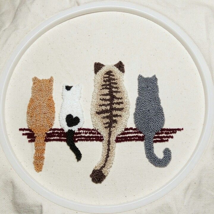 three cats are sitting on a branch in the hoop