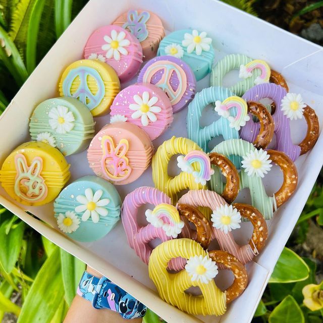 a box filled with assorted decorated doughnuts