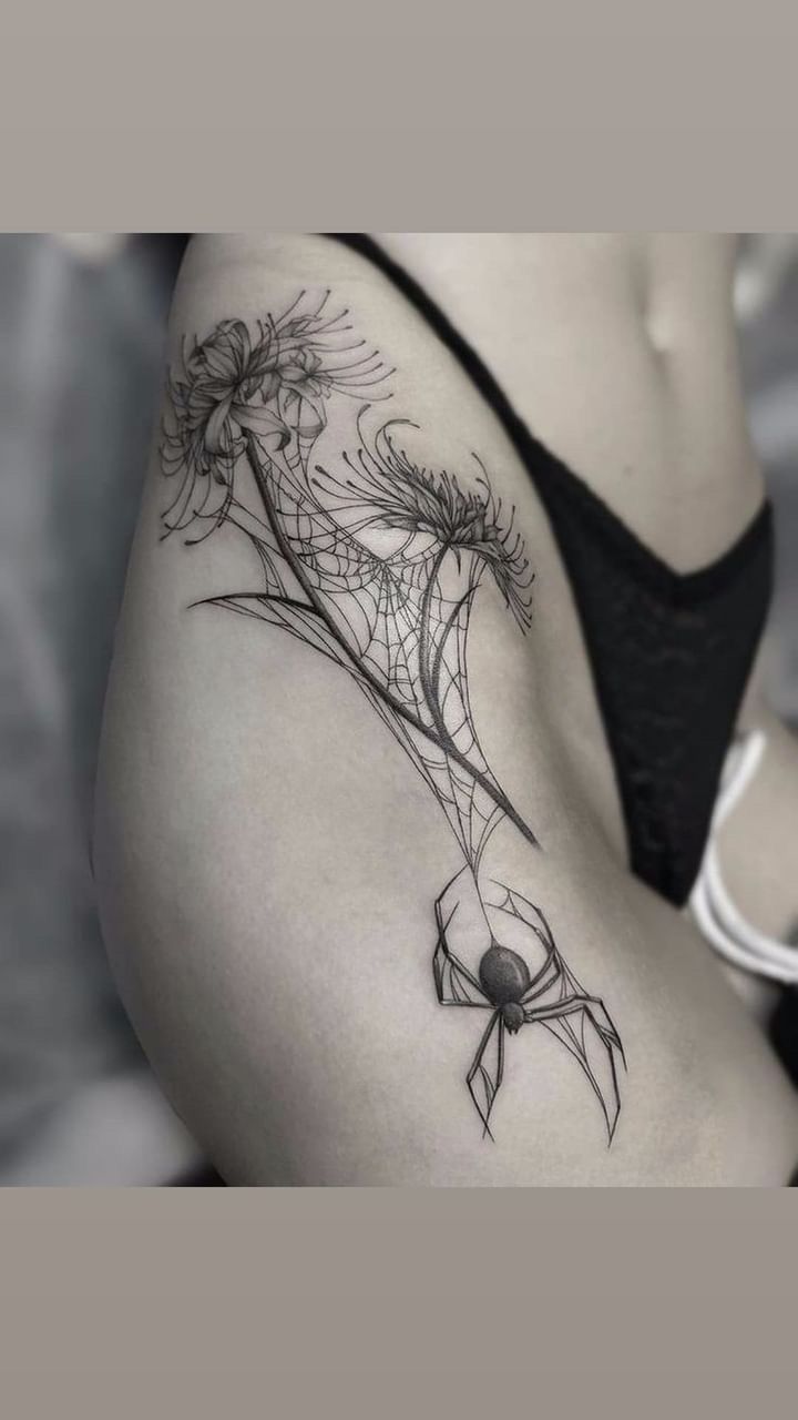 a woman's stomach with flowers on it and a spider crawling around the side