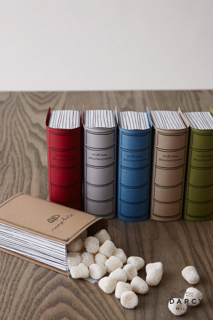 several books and some marshmallows on a table