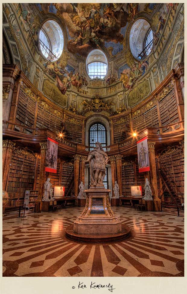 an ornate library with many bookshelves and sculptures