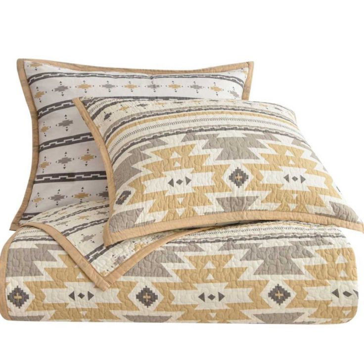 two pillows on top of each other with an orange and white pattern in the middle