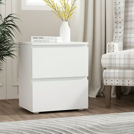 a white cabinet sitting in front of a window next to a chair and potted plant